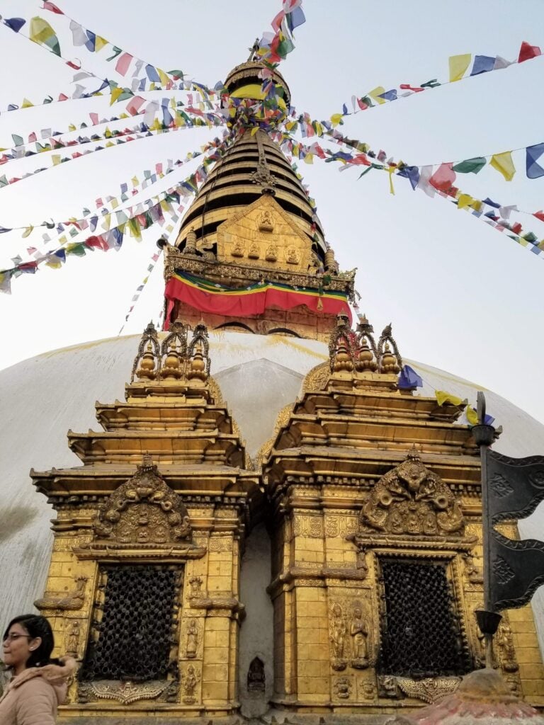 Gilded spire and prayer flags at Swayambhunath stupa, Kathmandu