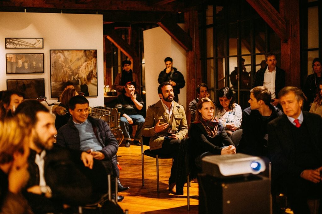 Group gathered for a talk in a wood-panelled room